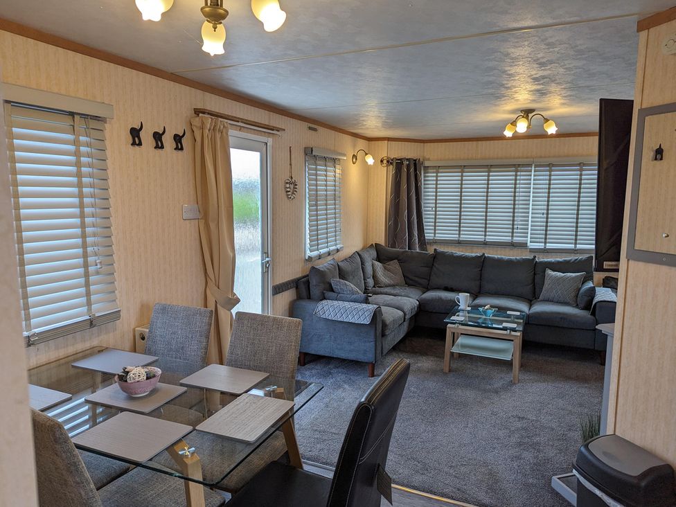 A living room with a sofa and dining table at the property