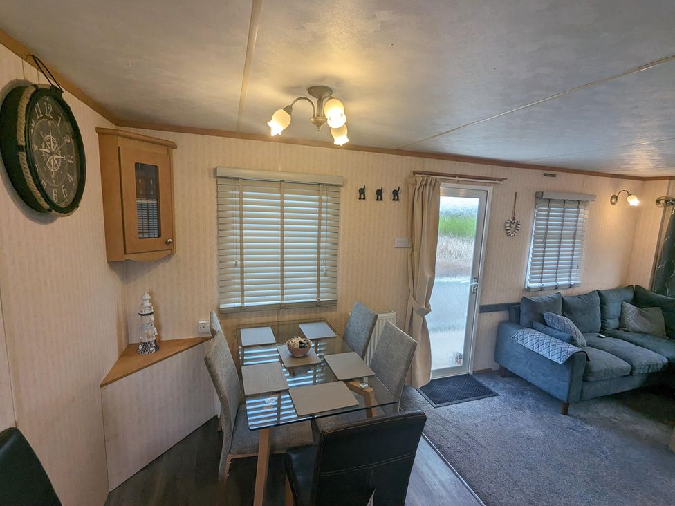 A dining room with a table and chairs at a property in an unknown location