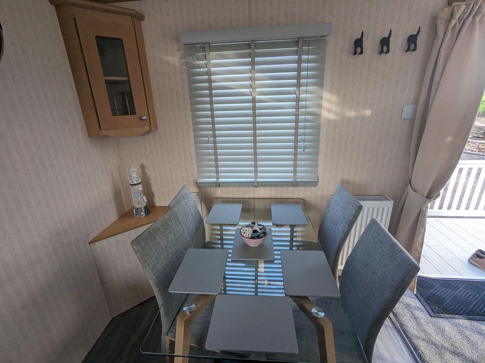 A dining room with a table and chairs at The Old Barn in Manchester