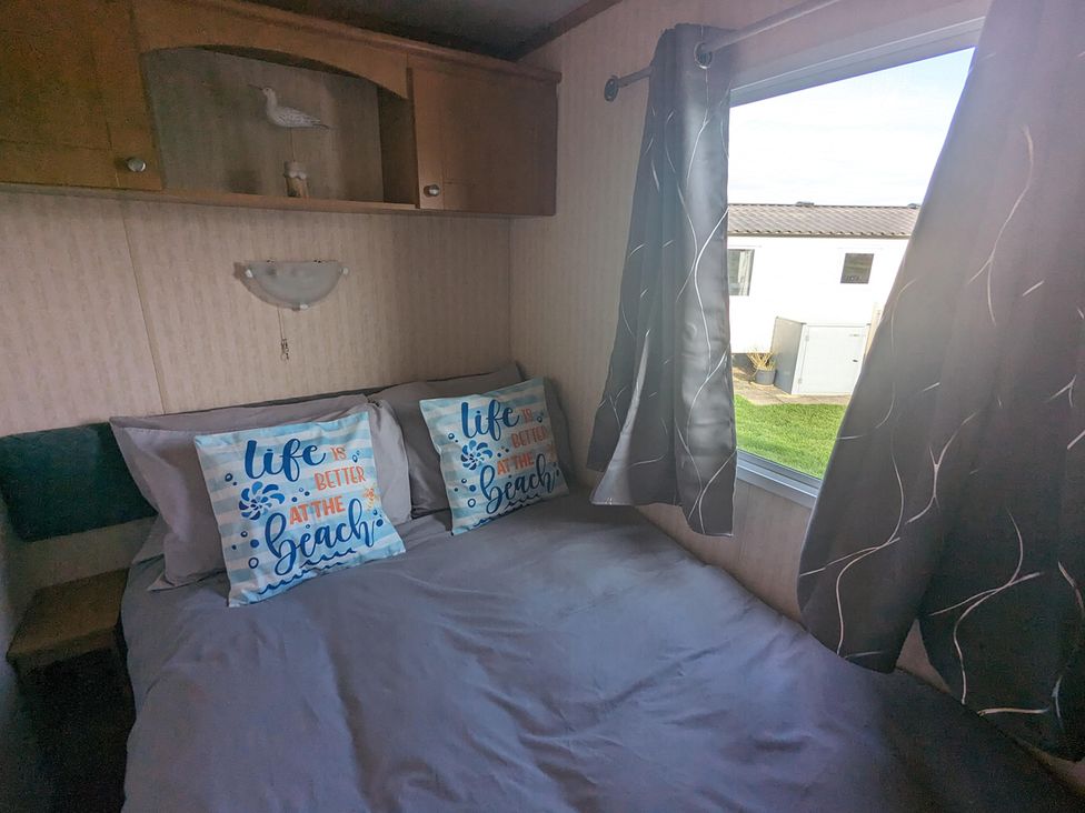 A bedroom with pillows on a bed at 