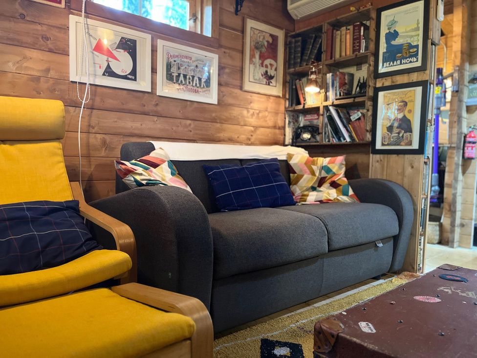 A living room with a sofa and bookshelves at an unspecified location