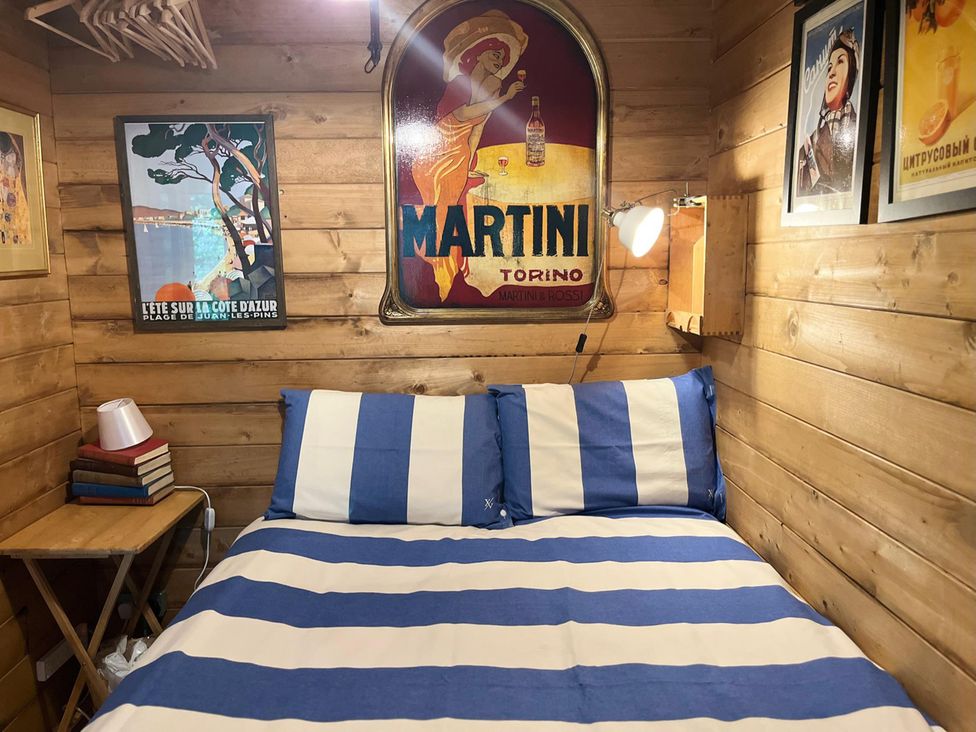 A bedroom with a bed and wall art at The Old Barn in Manchester