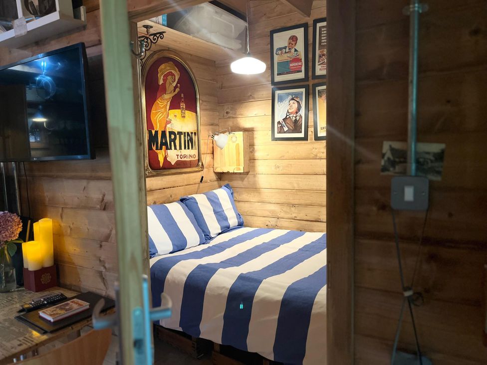 A bedroom with a bed and television at The Old Barn in Manchester