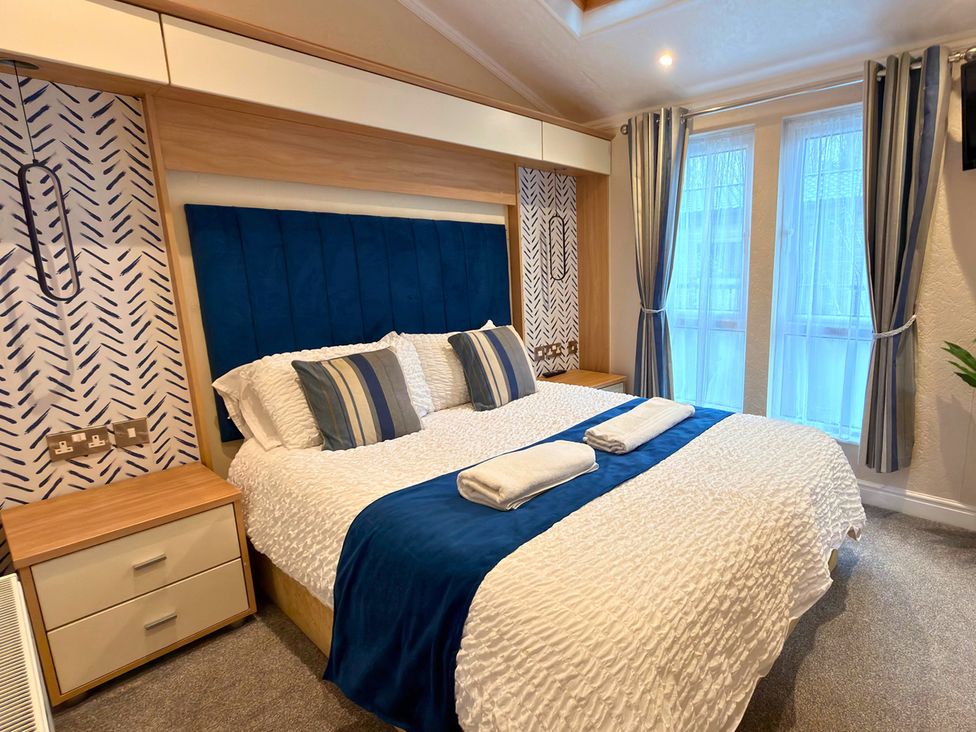A bedroom with a bed and curtains at the property
