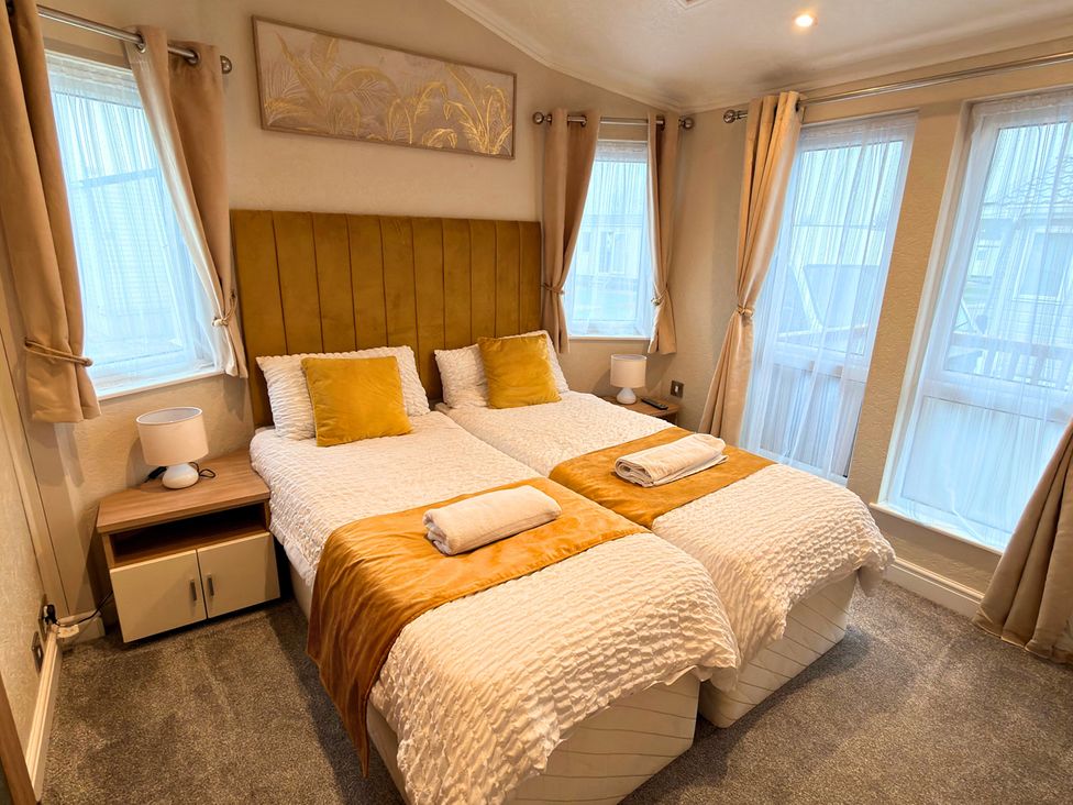 A bedroom with two beds and a nightstand at 