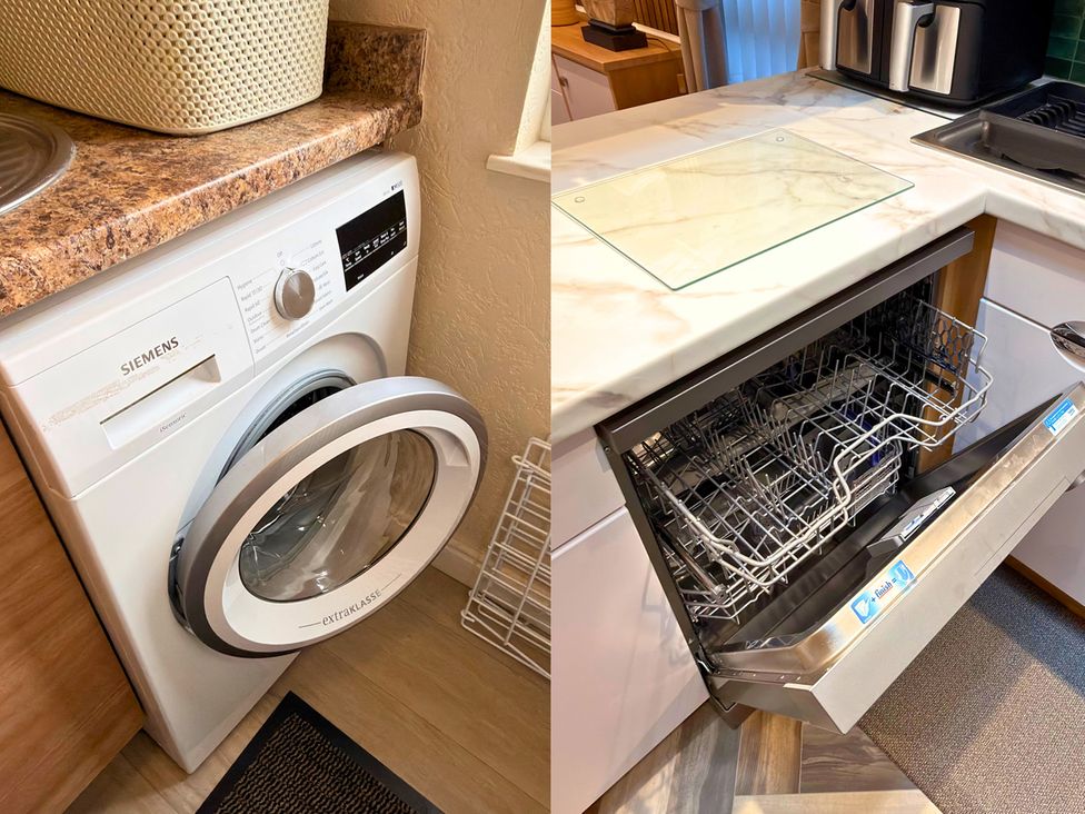 A washing machine and a dishwasher in a kitchen with a countertop at the property in location
