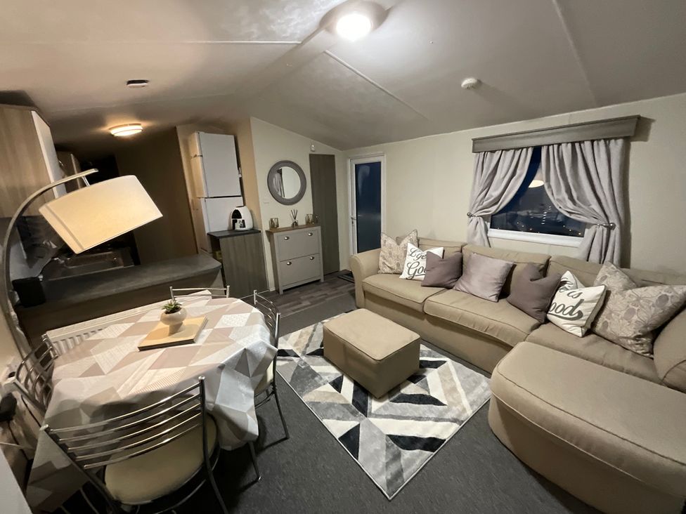 A living room with a sofa and dining table at an unspecified location