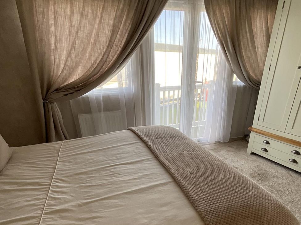 A bedroom with a bed and a wardrobe at the property