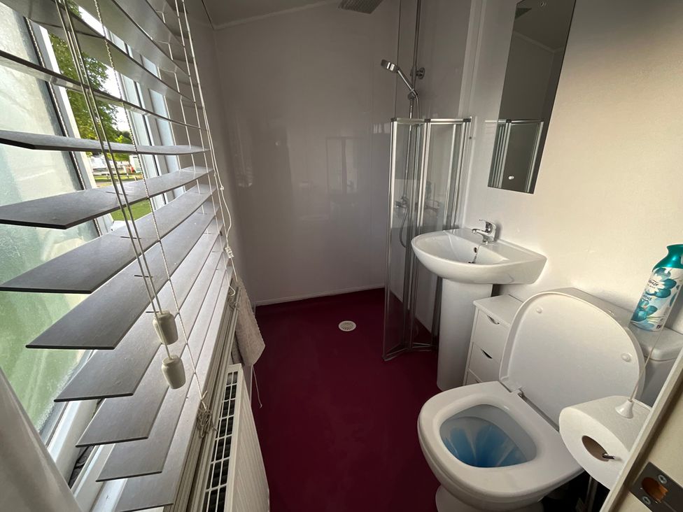 A bathroom with a shower, sink, and toilet at the property.
