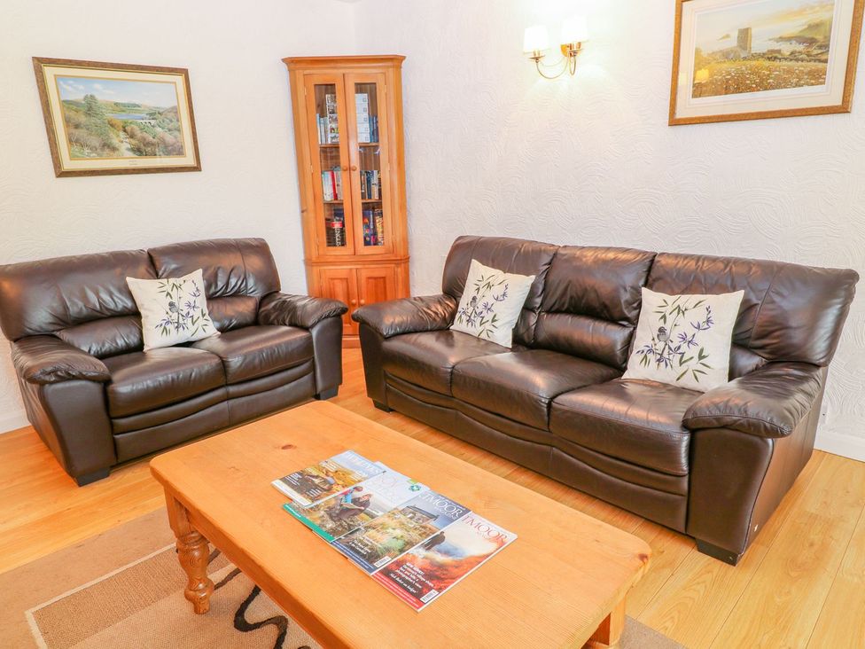 A living room with sofas and a coffee table at Maple Cottage in Tavistock