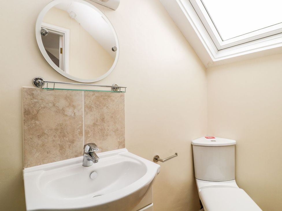 A bathroom with a sink and toilet at Honeysuckle in Tavistock