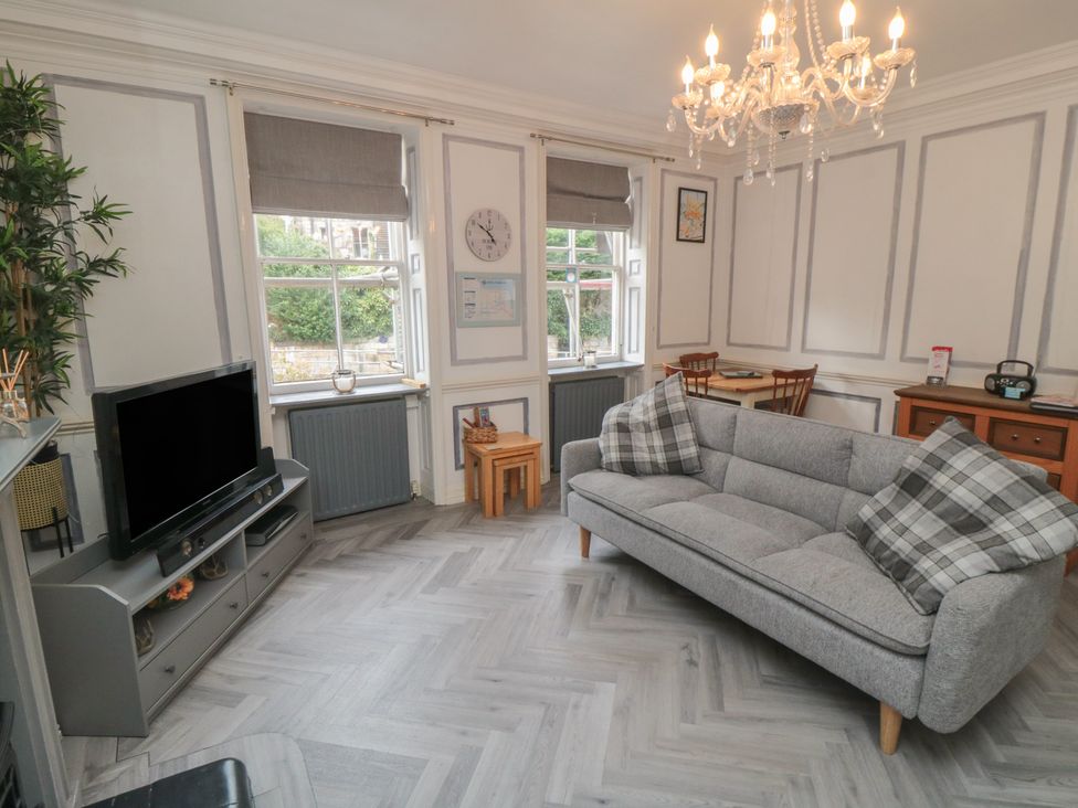 A living room with a sofa and television at The Hyding Place in Whitby