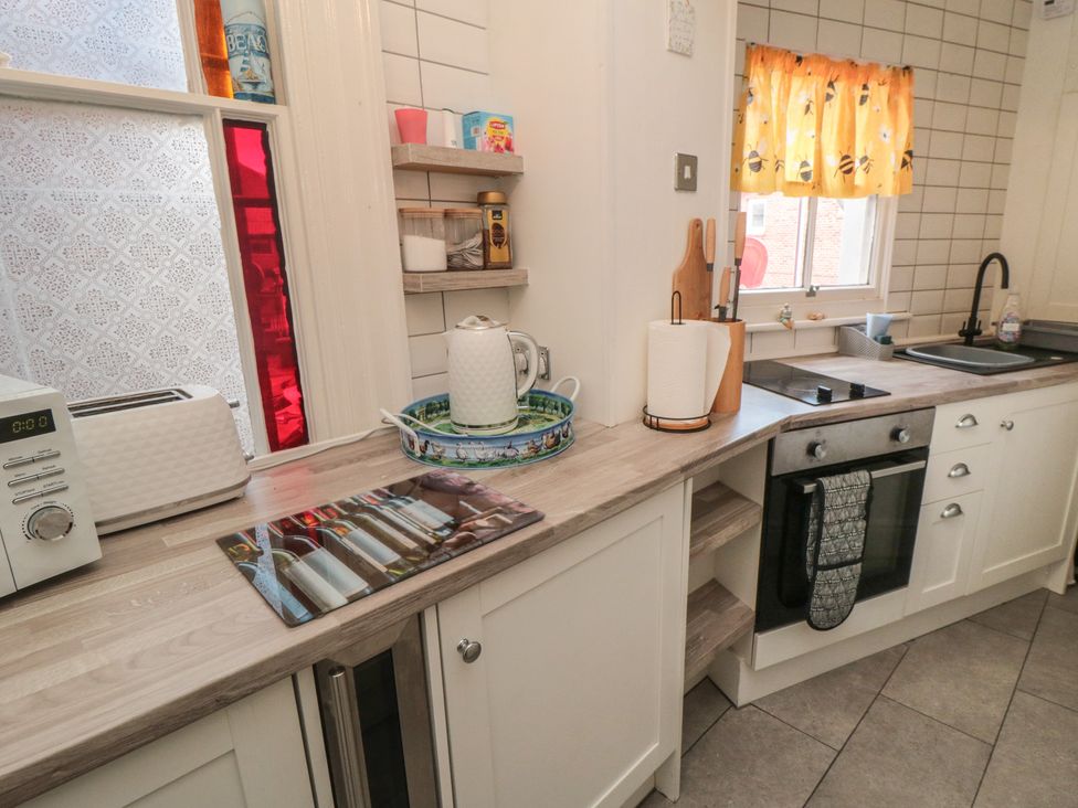A kitchen with a toaster and kitchen sink at The Hyding Place in Whitby