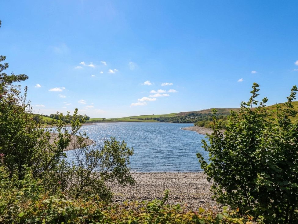 A view of a river surrounded by hills and trees at Three Mile House in Carnforth