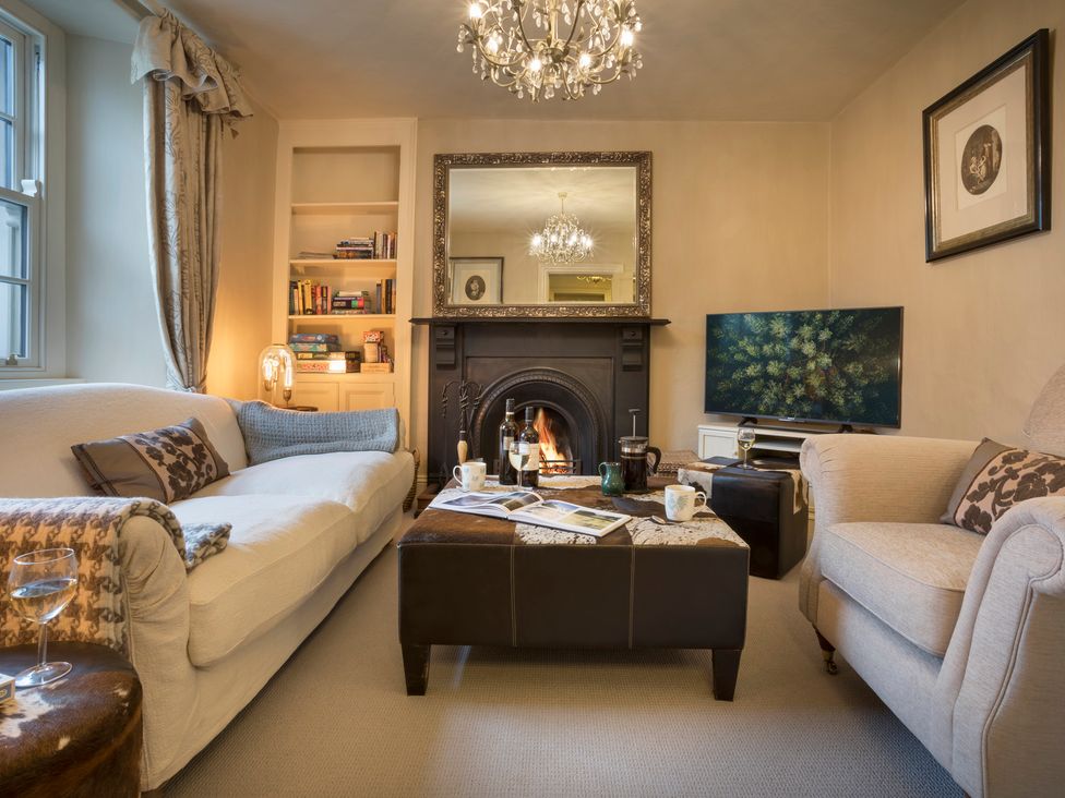 A living room with a sofa and fireplace at Three Mile House in Carnforth