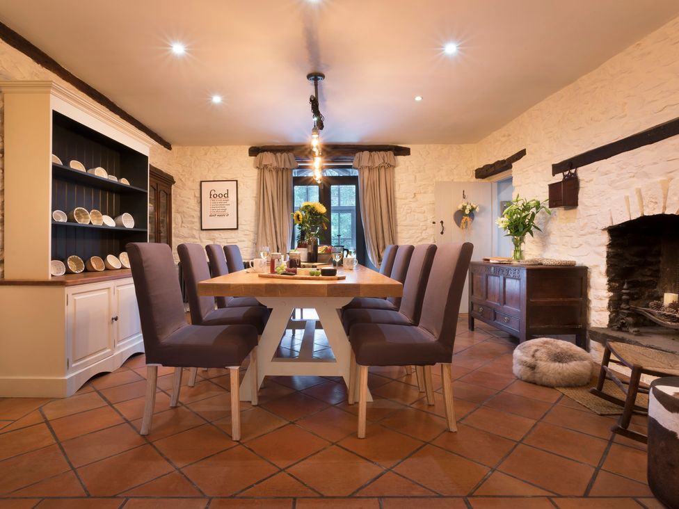 A dining room with a table and chairs at Three Mile House in Carnforth