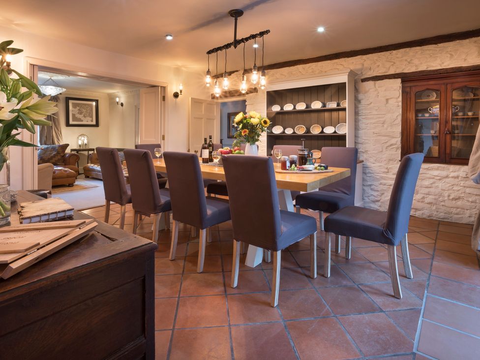 A dining room with a table and chairs at Three Mile House in Carnforth