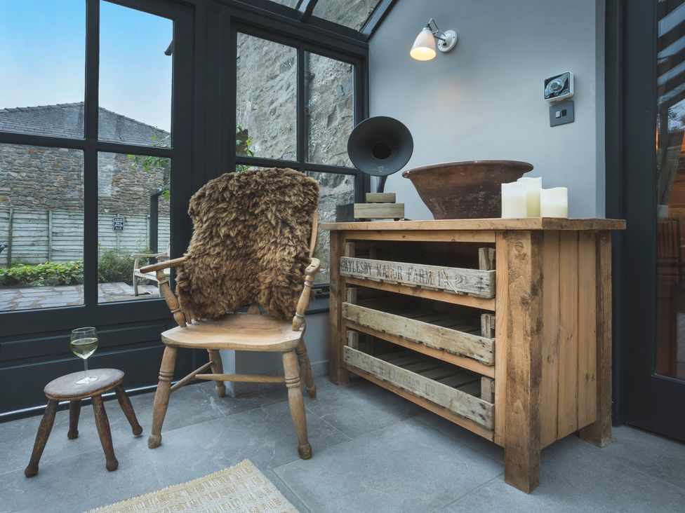 A snug with a chair and table at Three Mile House in Carnforth