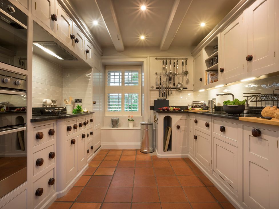 A kitchen with cabinets, countertop, and appliances at Three Mile House in Carnforth