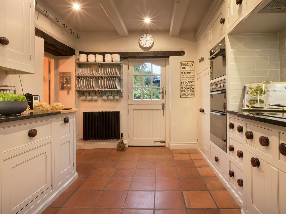 A kitchen with cabinets and appliances at Three Mile House in Carnforth
