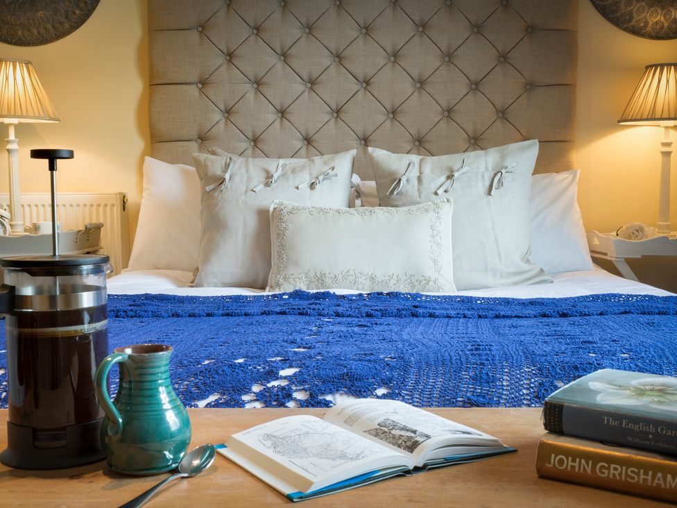 A bedroom with a bed and coffee on a table at Three Mile House in Carnforth