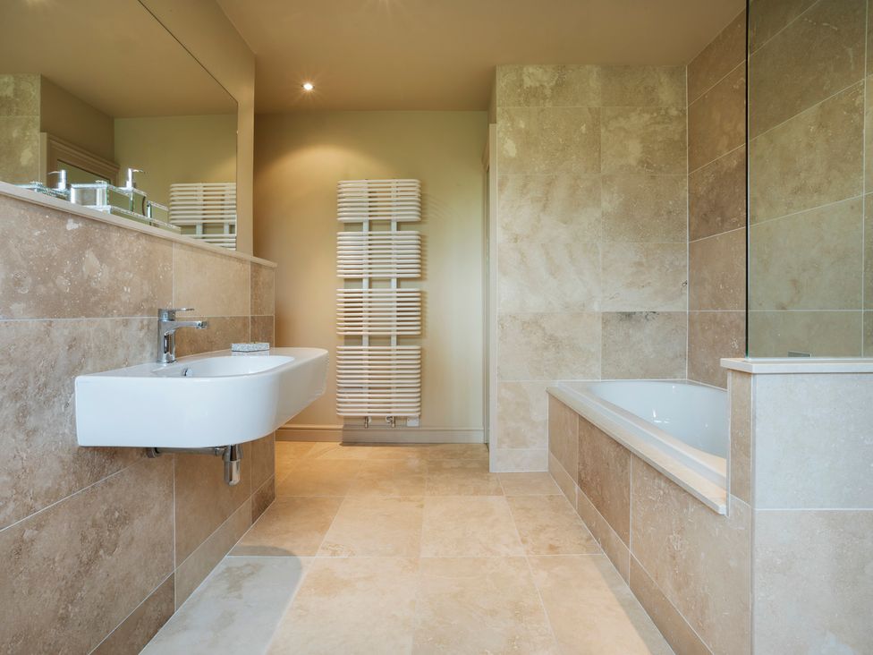 A bathroom with a sink and bathtub at Three Mile House in Carnforth