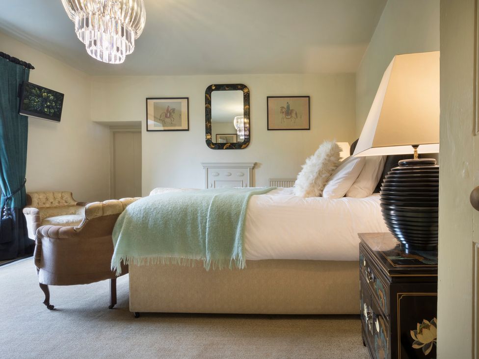 A bedroom with a bed and a couch at Three Mile House in Carnforth