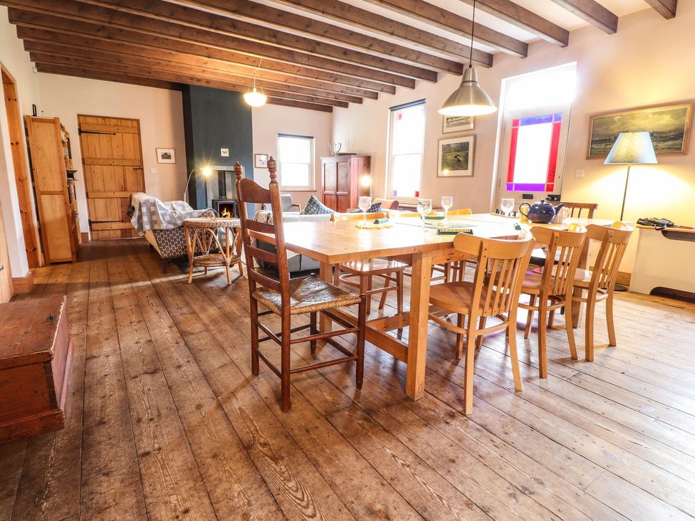 A dining room with a table and chairs at Llys Gwaun in Fishguard