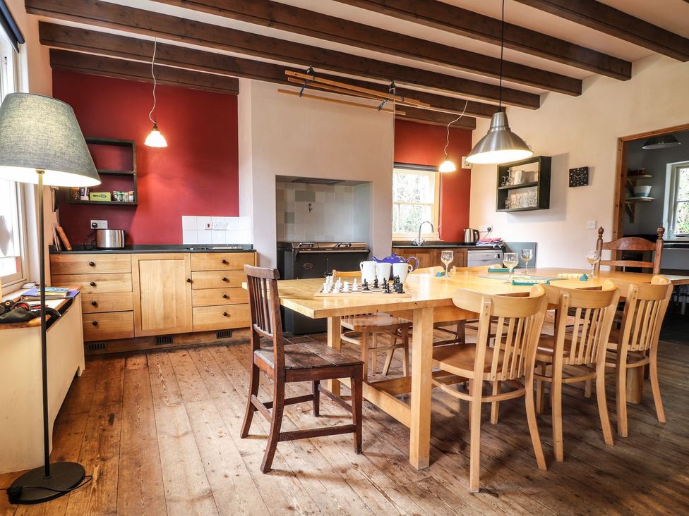 A kitchen with a table and chairs at Llys Gwaun in Fishguard