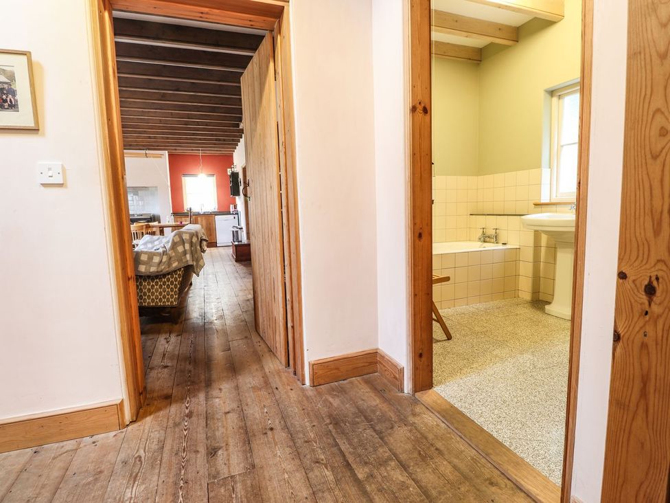 A bathroom with a bathtub and sink at Llys Gwaun in Fishguard