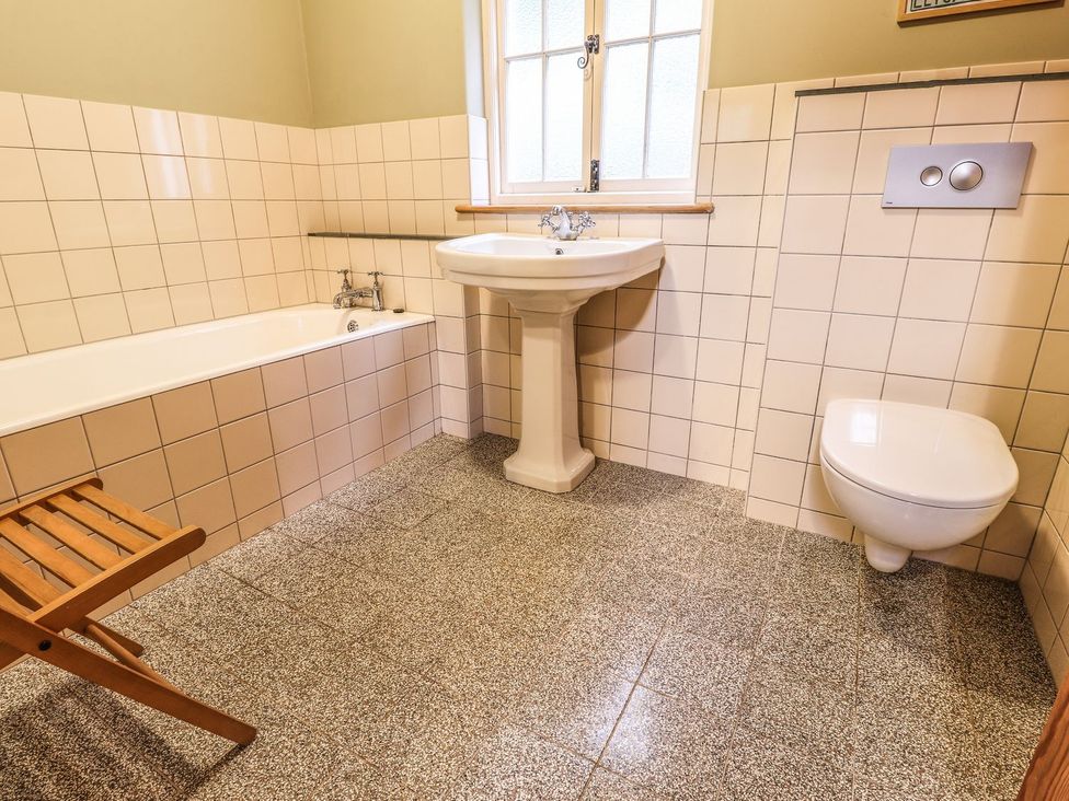 A bathroom with a bathtub, sink, and toilet at Llys Gwaun in Fishguard