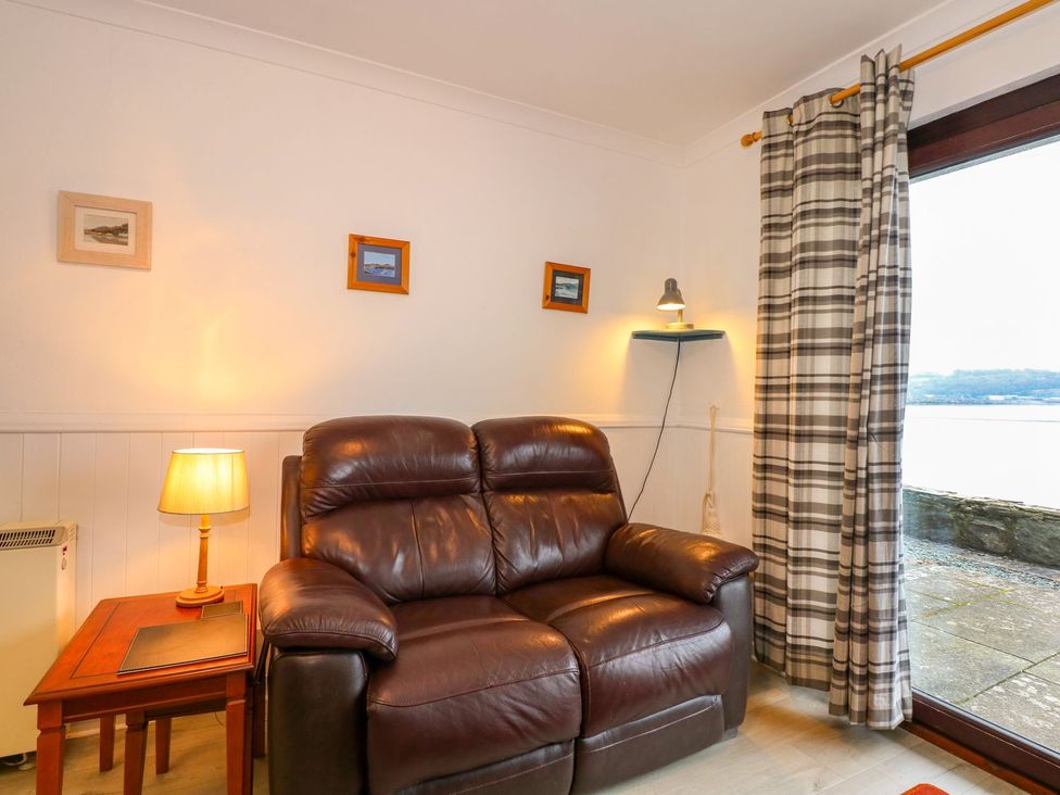 A living room with a sofa and lamp at Aldena South Snowdon Wharf Porthmadog