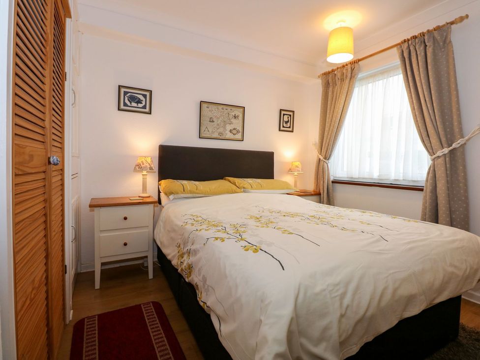 A bedroom with a bed and bedside table at Aldena South Snowdon Wharf in Porthmadog