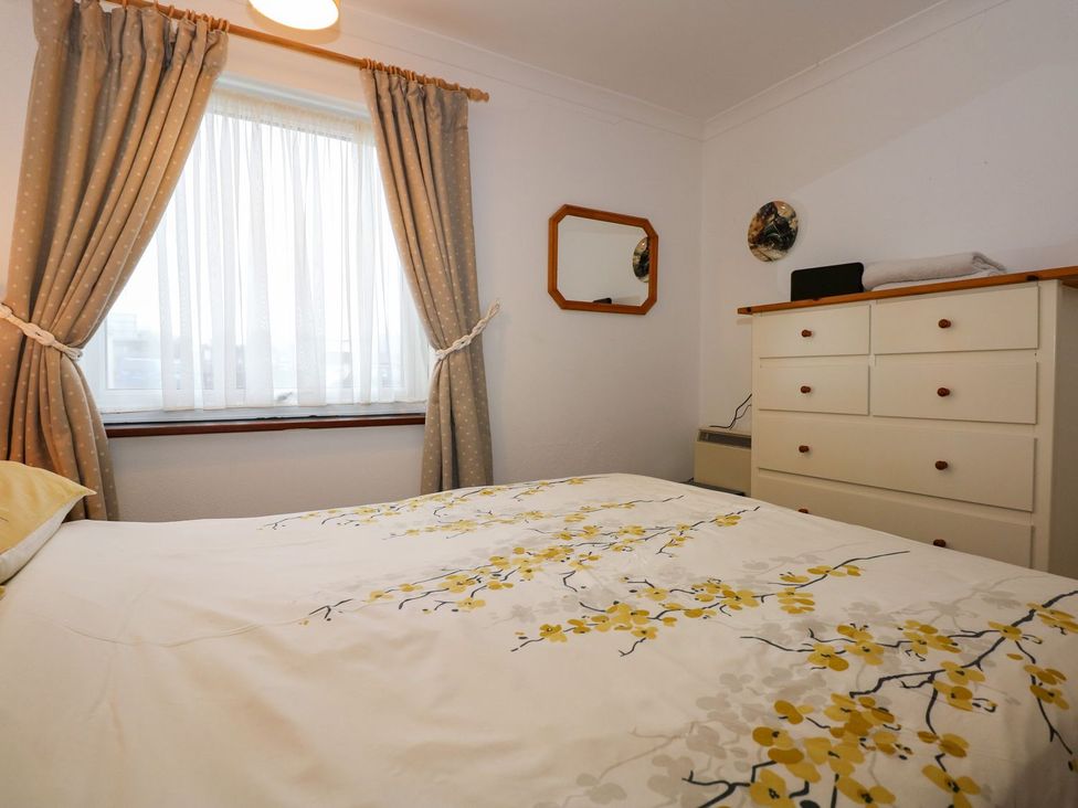 A bedroom with a bed and chest of drawers at Aldena South Snowdon Wharf Porthmadog