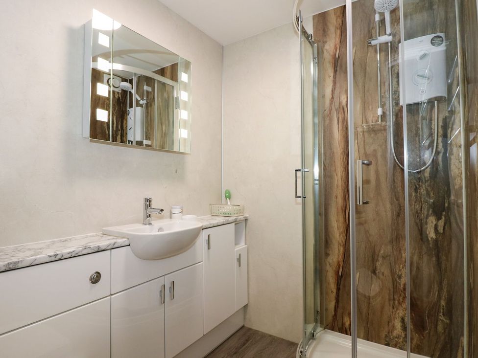 A bathroom with a sink and shower at Aldena South Snowdon Wharf in Porthmadog