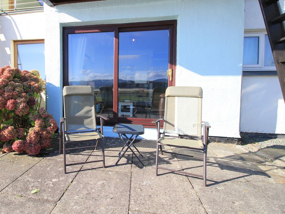 An outdoor seating area with two chairs and a table at Aldena South Snowdon Wharf in Porthmadog
