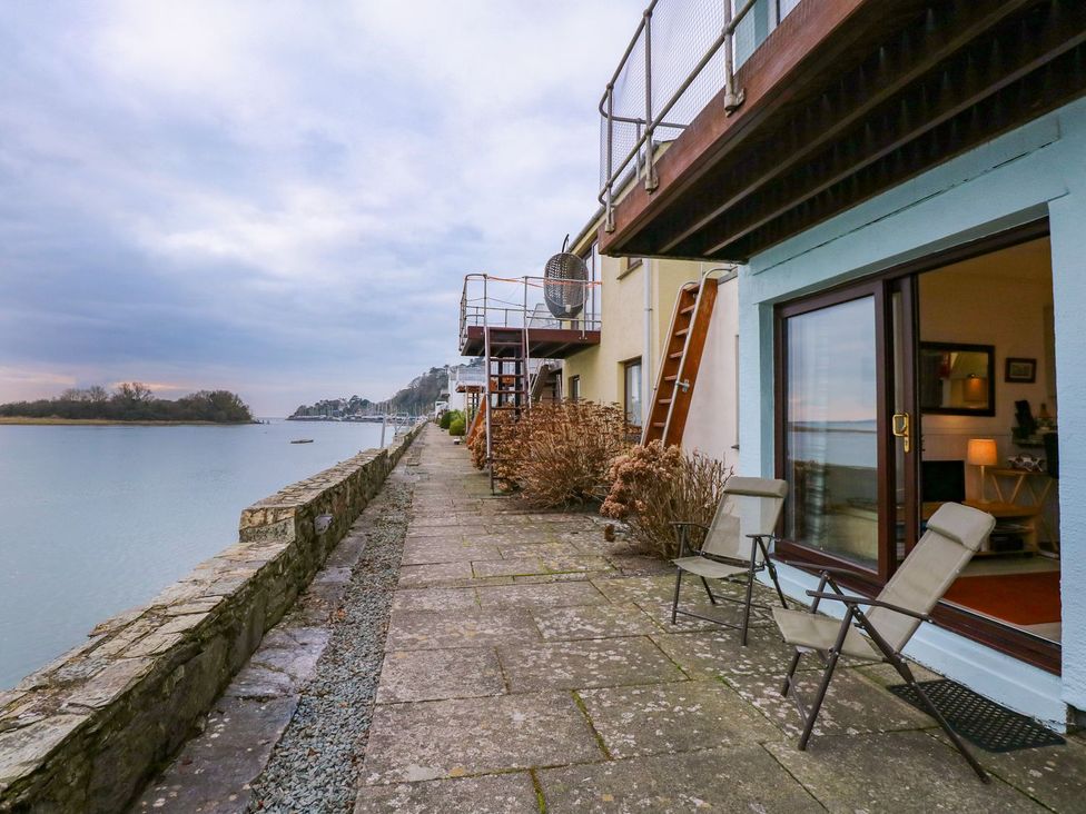An outdoor area with a pathway alongside a river at Aldena South Snowdon Wharf in Porthmadog