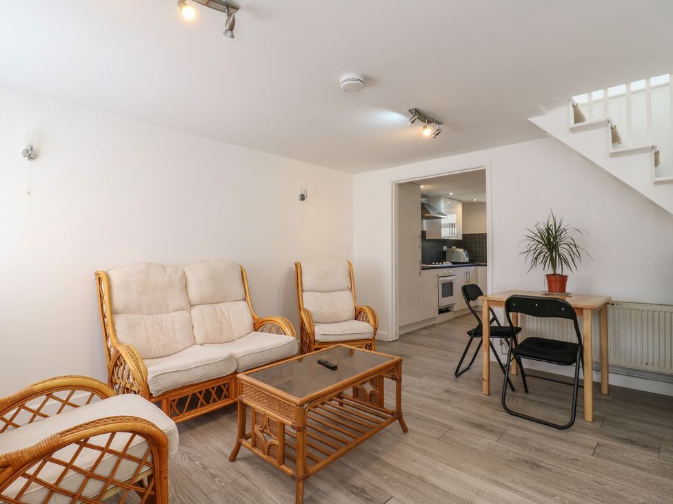 A living room with seating and a dining table at 2B Granville Road Colchester