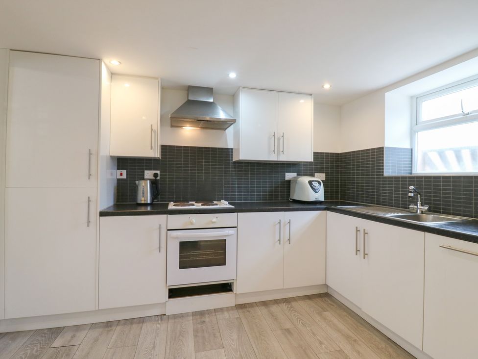 A kitchen with cabinets and appliances at 2B Granville Road, Colchester