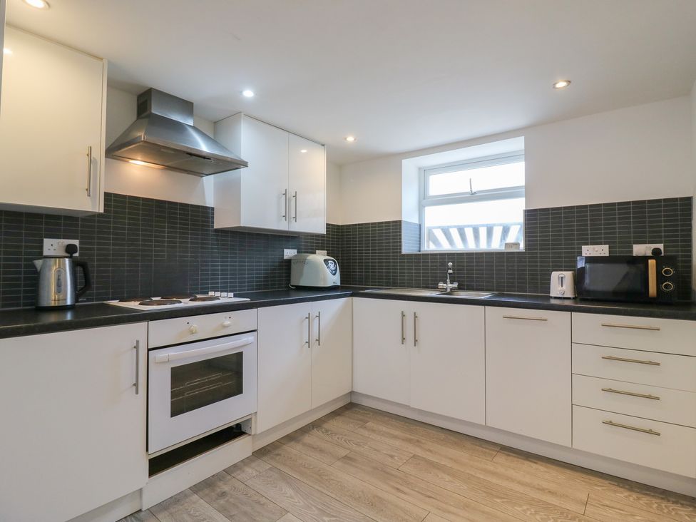 A kitchen with appliances and cabinetry at 2B Granville Road, Colchester