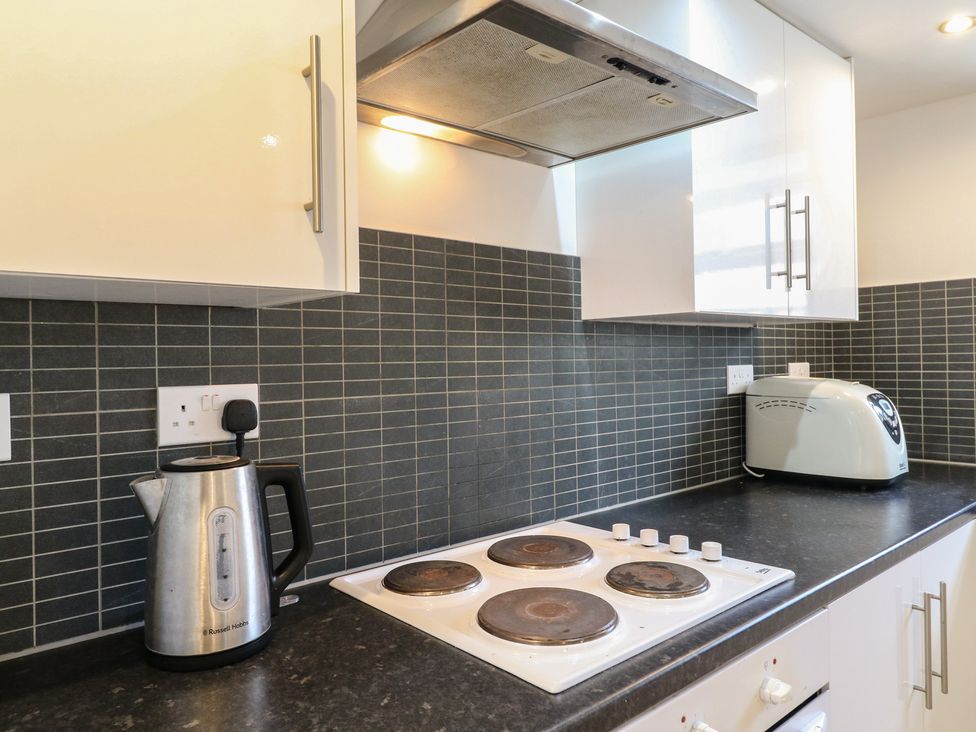 A kitchen with a kettle, cooker, and toaster at 2B Granville Road, Colchester