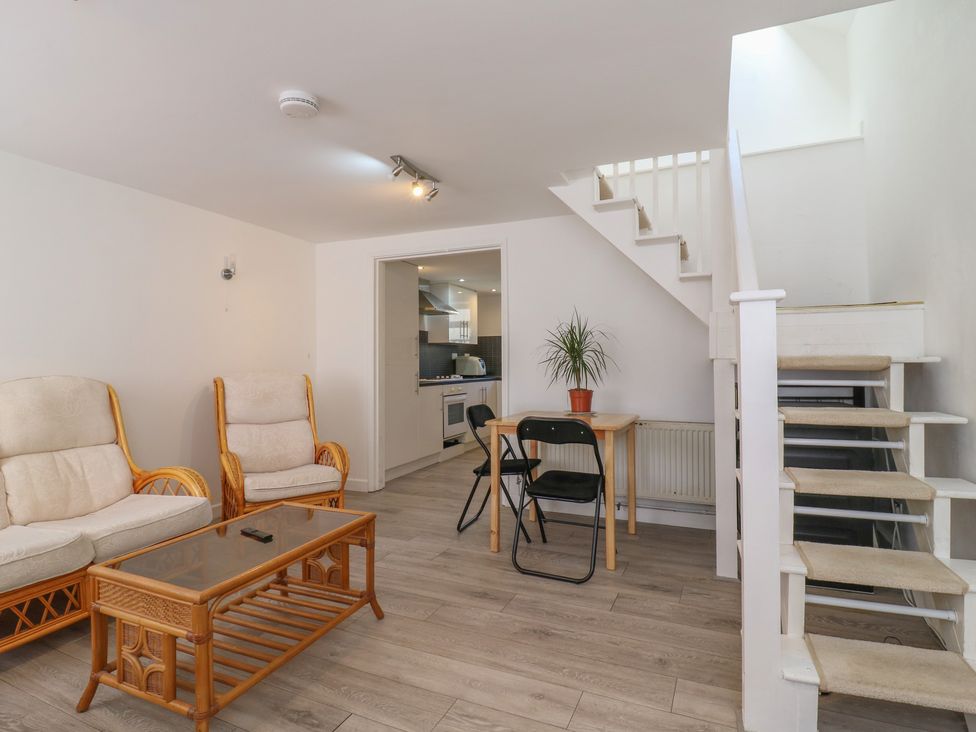 A living room with furniture and stairs at 2B Granville Road in Colchester