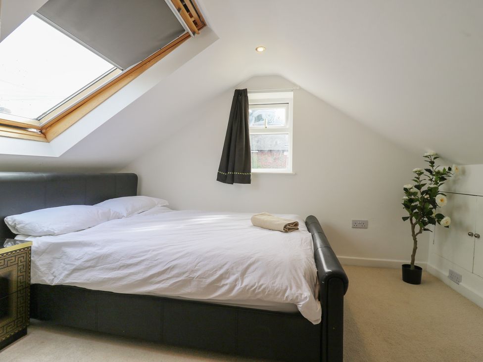 A bedroom with a bed and a plant at 2B Granville Road, Colchester