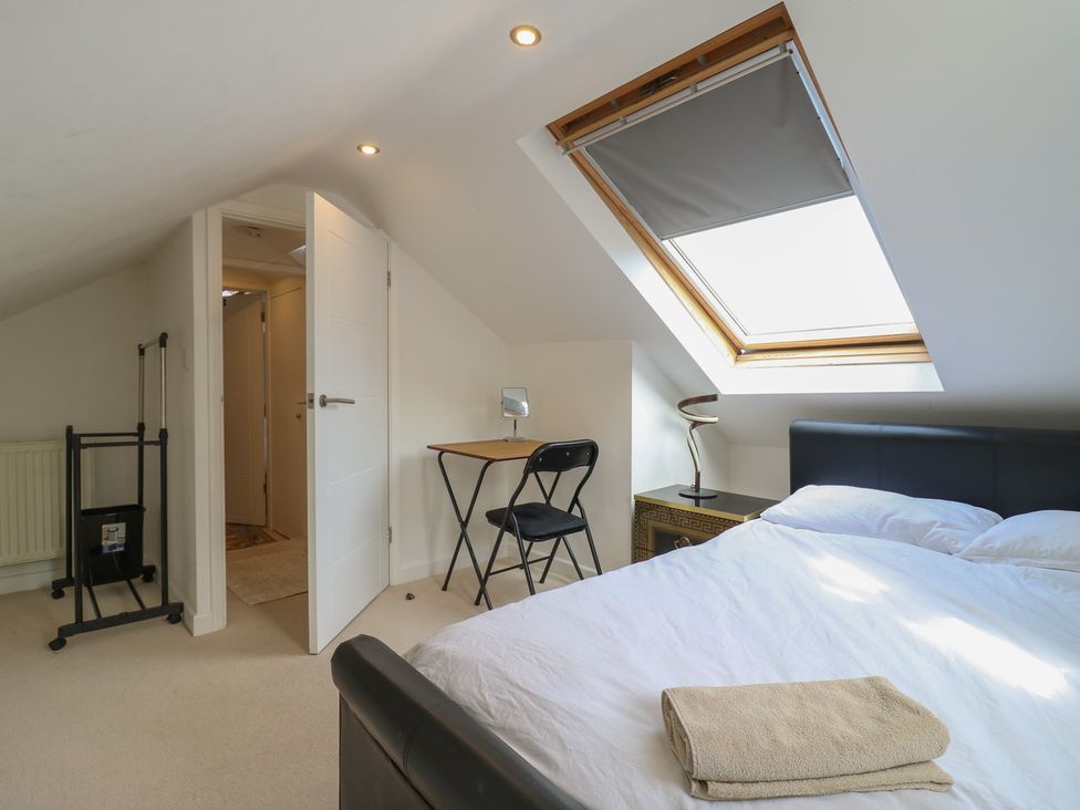 A bedroom with a bed, desk, and window at 2B Granville Road, Colchester