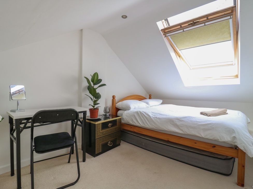 A bedroom with a bed, desk and a chair at 2B Granville Road in Colchester