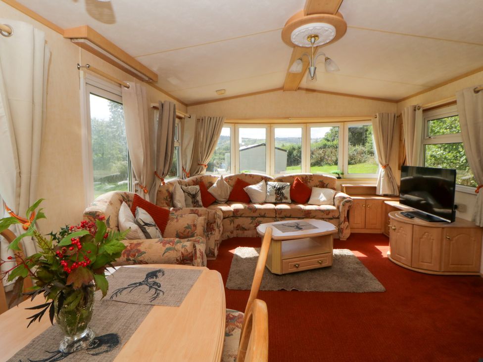 A living room with a sofa and television at Leven in Lampeter