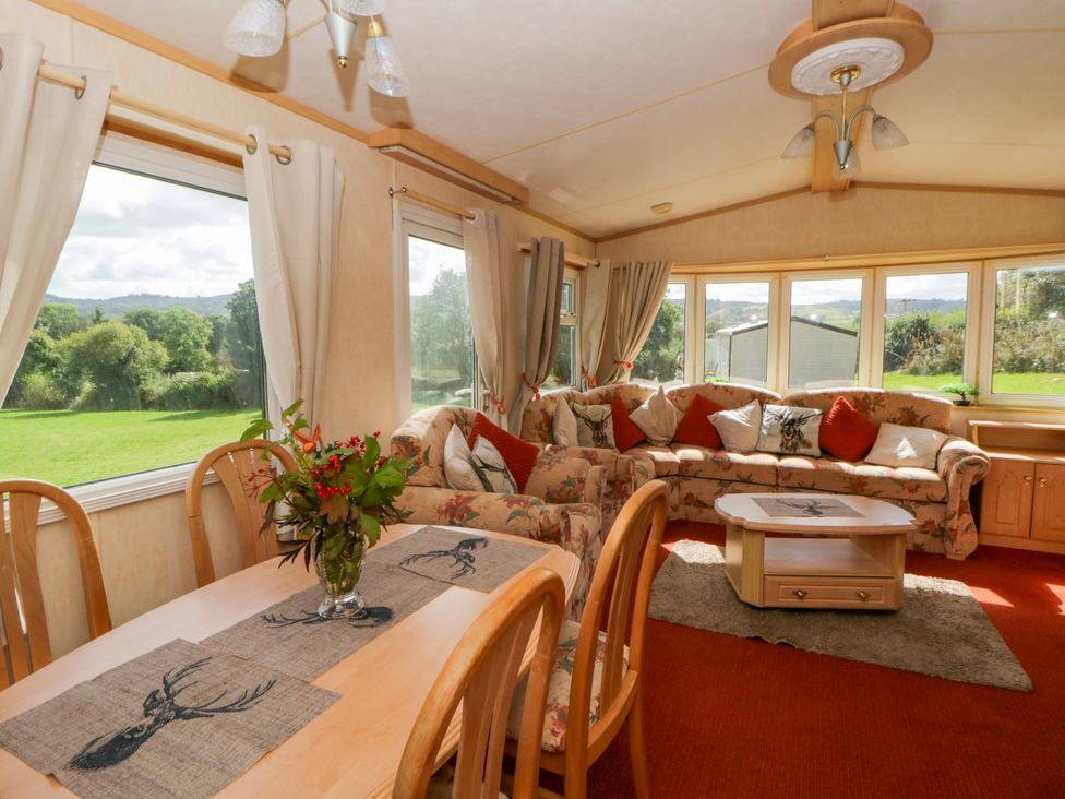 A snug with a sofa and dining table at Leven in Lampeter