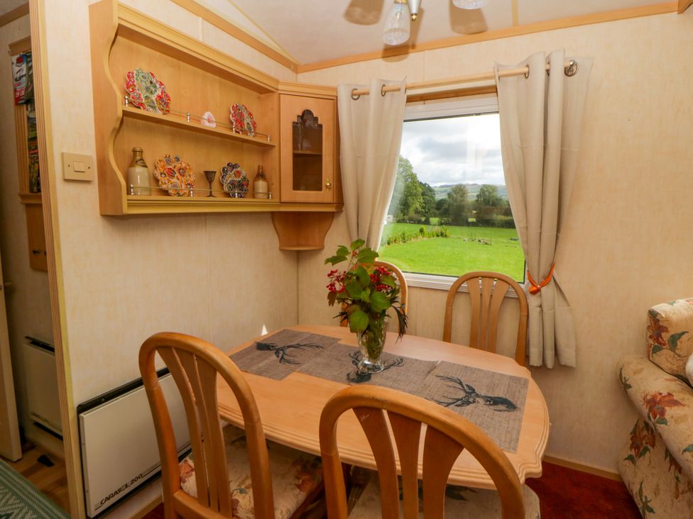 A dining room with a table and chairs at Leven in Lampeter
