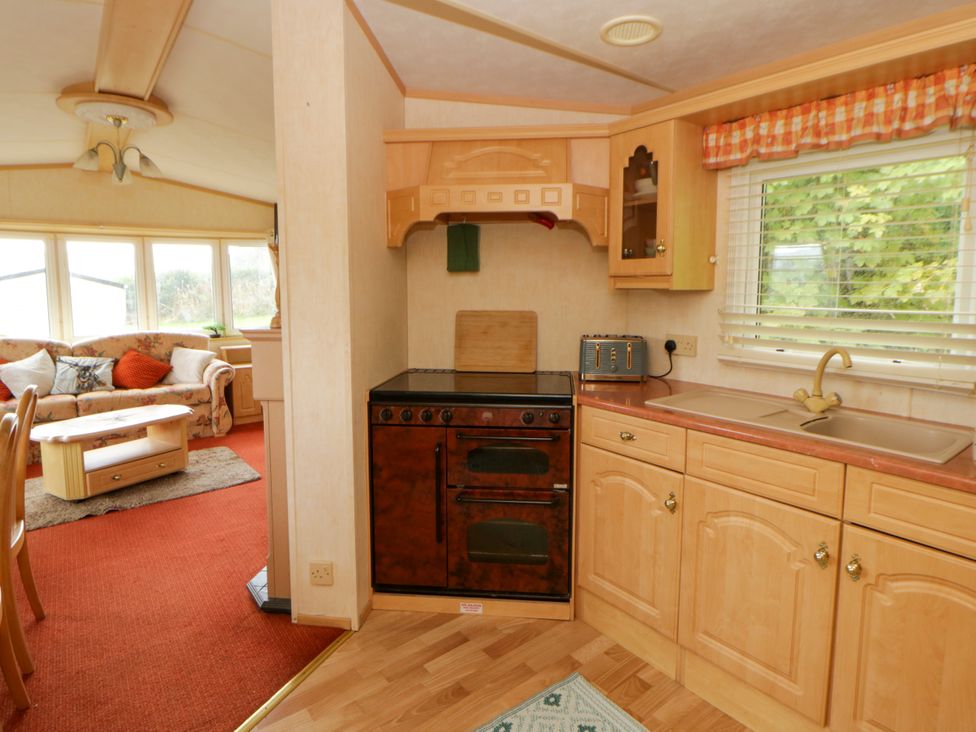 A kitchen with a stove and sink at Leven in Lampeter