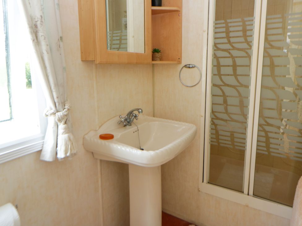 A bathroom with a sink and shower at Leven Lampeter